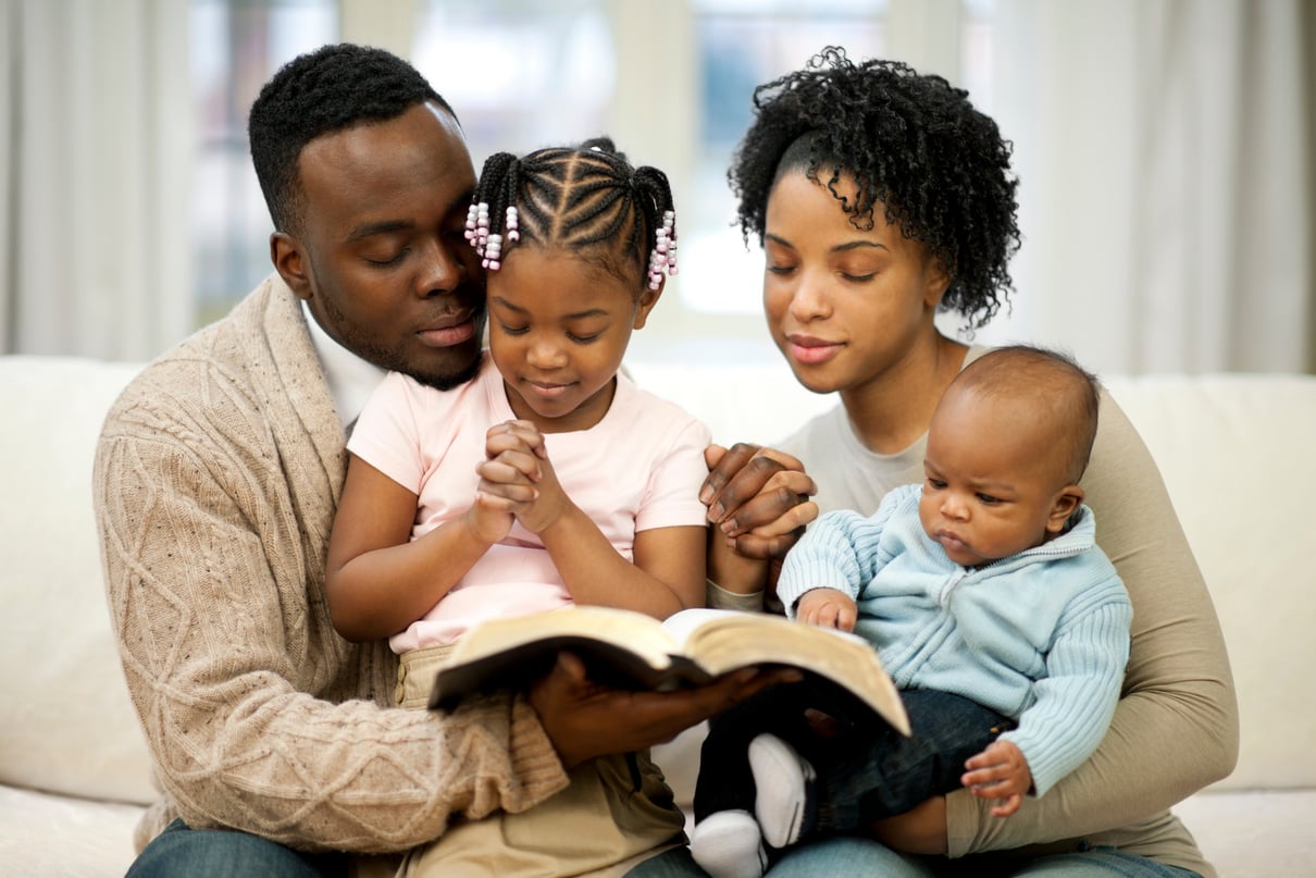 Family Praying on the Living Room Couch 